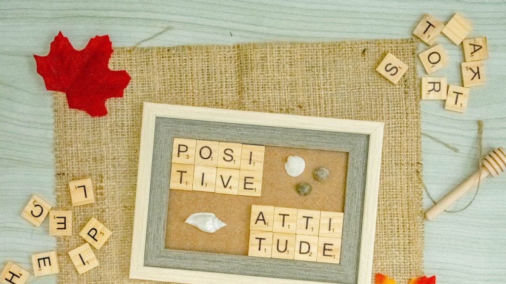 a picture frame surrounded by scrabbles and autumn leaves